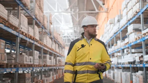 Worker male warehouse worker engineer man in a helmet working on the Stock Footage 114474921