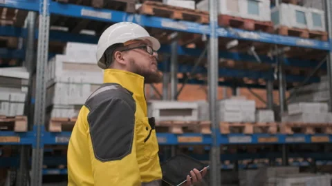 Worker male warehouse worker engineer man in a helmet working on the Video stock 114475407