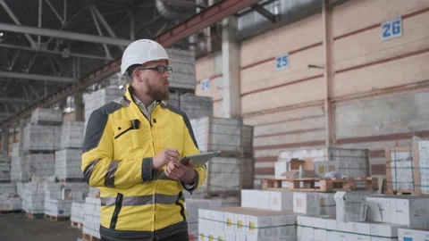 Worker male warehouse worker engineer man in a helmet working on the Stock Footage 114476906