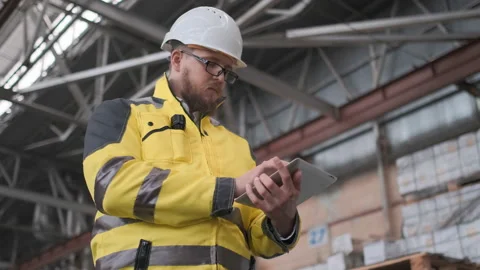 Worker male warehouse worker engineer man in a helmet working on the Stock Footage 114477031