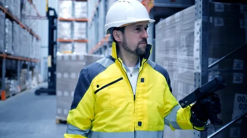 Worker male warehouse worker engineer man in a helmet working on the Stock Footage 127925456