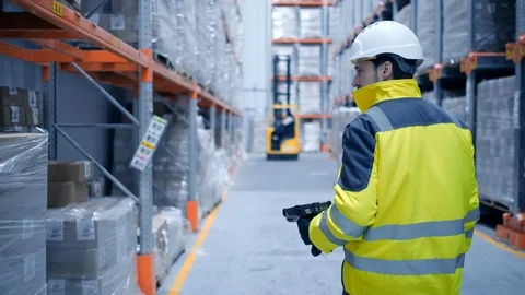 Worker male warehouse worker engineer man in a helmet working on the Stock Footage 127925843