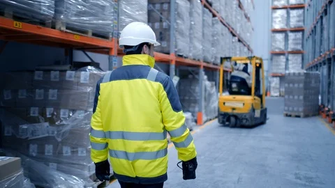 Worker male warehouse worker engineer man in a helmet working on the Stock Footage 127926704