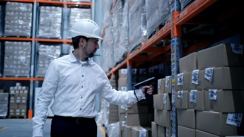 Worker male warehouse worker engineer man in a helmet working on the Stock Footage 127929038