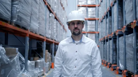 Worker male warehouse worker engineer man in a helmet working on the Stock Footage 127929462