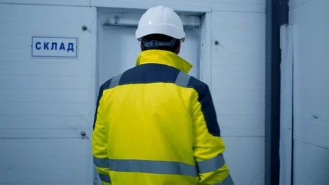 Worker male warehouse worker engineer man in a helmet working on the Stock Footage 127930117