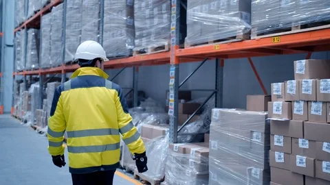 Worker male warehouse worker engineer man in a helmet working on the Stock Footage 127942166