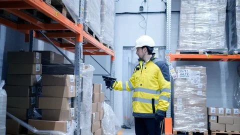 Worker male warehouse worker engineer man in a helmet working on the Stock Footage 127942484