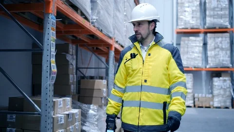 Worker male warehouse worker engineer man in a helmet working on the Stock Footage 127942692