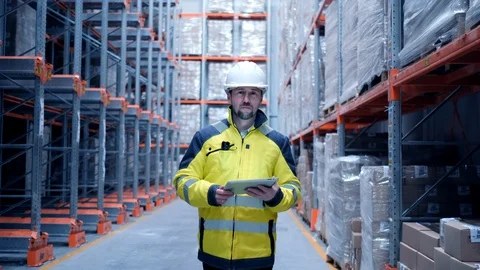 Worker male warehouse worker engineer man in a helmet working on the Stock Footage 127942900