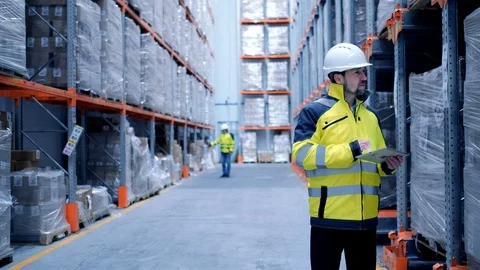 Worker male warehouse worker engineer man in a helmet working on the Stock Footage 127943214