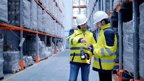 Worker male warehouse worker engineer man in a helmet working on the Stock Footage 127943422