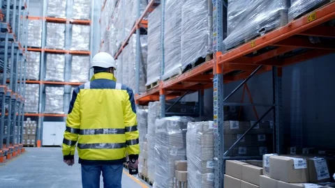 Worker male warehouse worker engineer man in a helmet working on the Stock Footage 128644368