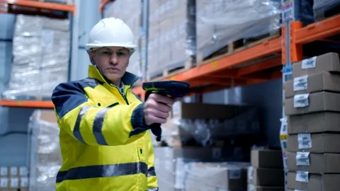 Worker male warehouse worker engineer man in a helmet working on the Stock Footage 128644503