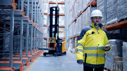 Worker male warehouse worker engineer man in a helmet working on the Stock Footage 128646275