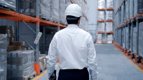 Worker male warehouse worker engineer man in a helmet working on the Stock Footage 129559871