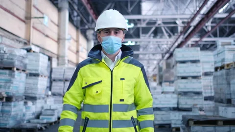 Worker male warehouse worker engineer man in a helmet working on the Stock Footage 147407708