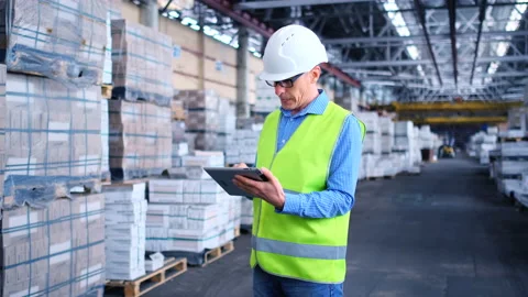 Worker male warehouse worker engineer man in a helmet working on the Stock Footage 147409111