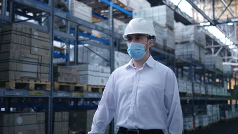 Worker male warehouse worker engineer man in a helmet working on the Stock Footage 147636545