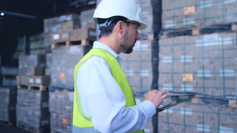 Worker male warehouse worker engineer man in a helmet working on the Stock Footage 147636729