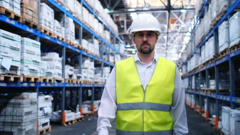 Worker male warehouse worker engineer man in a helmet working on the Stock Footage 148163836