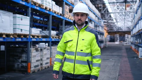 Worker male warehouse worker engineer man in a helmet working on the Stock Footage 157903466