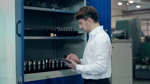 Worker male warehouse worker engineer man in a helmet working on the Stock Footage 172014566