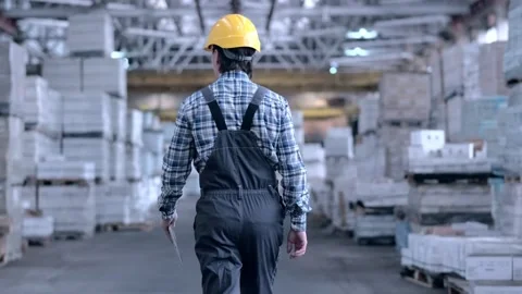 Worker male warehouse worker engineer man in a helmet working on the Stock Footage 172167514