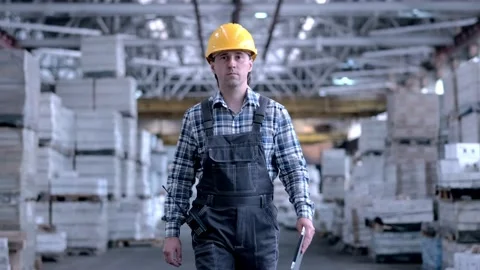 Worker male warehouse worker engineer man in a helmet working on the Stock Footage 172167530