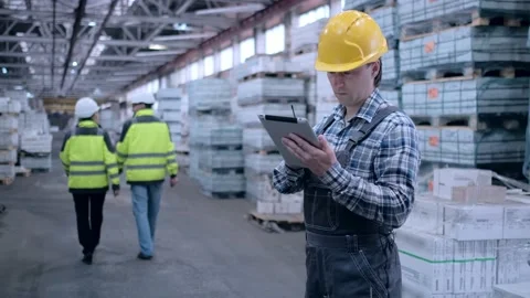 Worker male warehouse worker engineer man in a helmet working on the Stock Footage 172167691