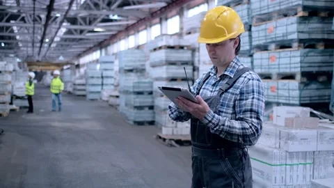 Worker male warehouse worker engineer man in a helmet working on the Stock Footage 172167714