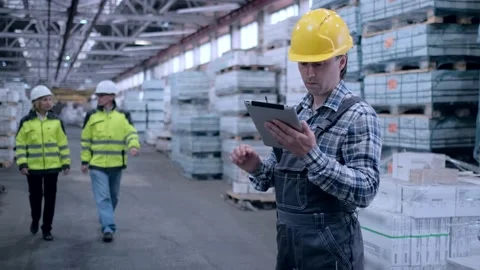 Worker male warehouse worker engineer man in a helmet working on the Stock Footage 172167760