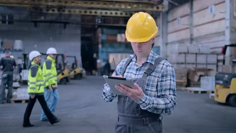 Worker male warehouse worker engineer man in a helmet working on the Stock Footage 172167782