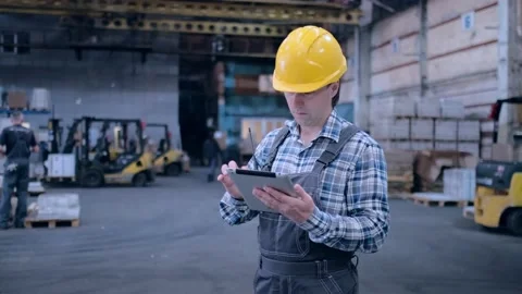Worker male warehouse worker engineer man in a helmet working on the Stock Footage 172167783