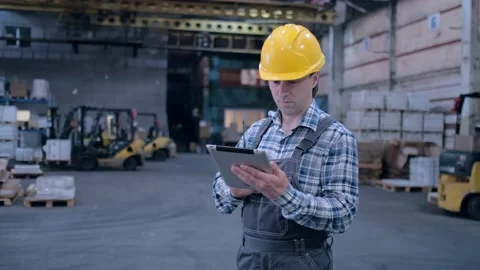 Worker male warehouse worker engineer man in a helmet working on the Stock Footage 172167814
