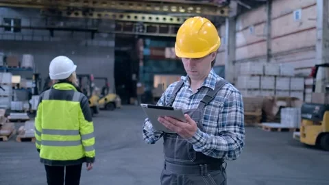 Worker male warehouse worker engineer man in a helmet working on the Stock Footage 172167823