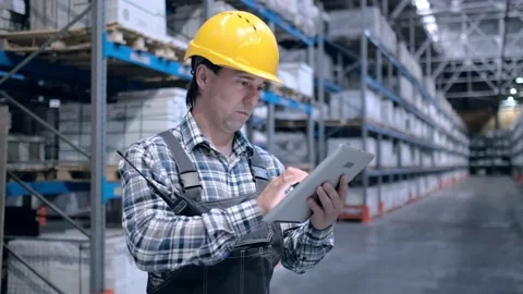 Worker male warehouse worker engineer man in a helmet working on the Stock Footage 172168041