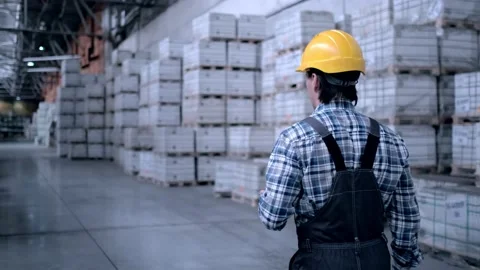 Worker male warehouse worker engineer man in a helmet working on the Stock Footage 172168205