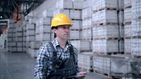 Worker male warehouse worker engineer man in a helmet working on the Stock Footage 172168226