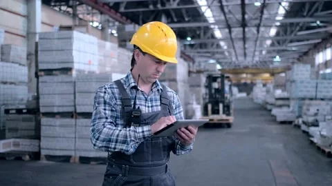 Worker male warehouse worker engineer man in a helmet working on the Stock Footage 172168269