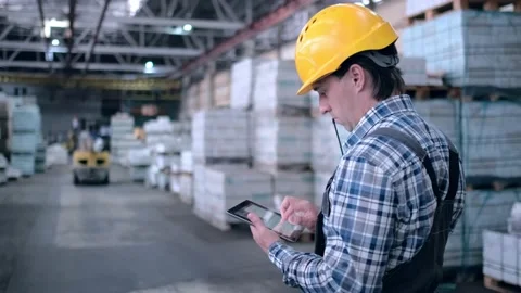 Worker male warehouse worker engineer man in a helmet working on the Stock Footage 172168272