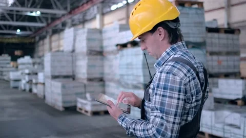 Worker male warehouse worker engineer man in a helmet working on the Stock Footage 172168282