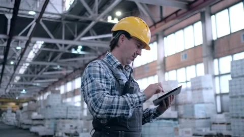 Worker male warehouse worker engineer man in a helmet working on the Stock Footage 172168291