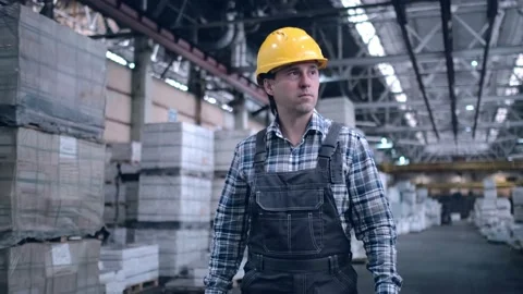 Worker male warehouse worker engineer man in a helmet working on the Stock Footage 172168307