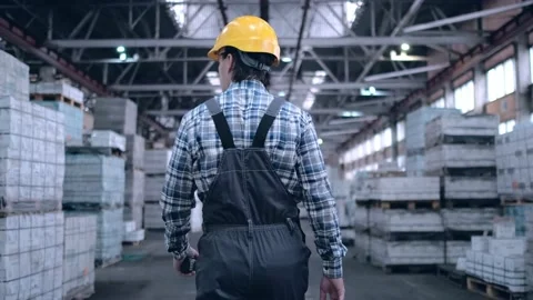 Worker male warehouse worker engineer man in a helmet working on the Stock Footage 172168315