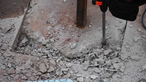 Worker man chipping away the concrete floor in a house Stock Footage 138071544