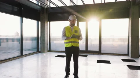 Worker Man Engineer Uses Tablet at Modern Unfinished Business Center. Male Civil Stock Footage 234083129