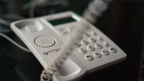 Worker Man hand picking up the landline phone to answer a call retro telephone Stock-Footage 229856444