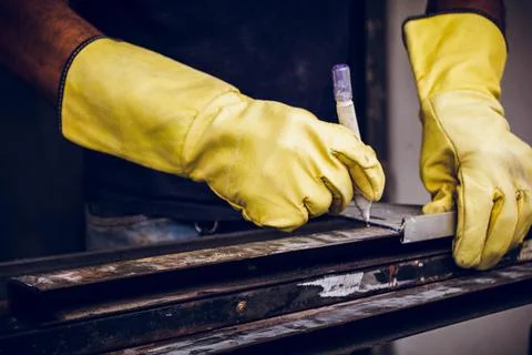 Worker man hands with white marker marking to cut metal Stock Photos