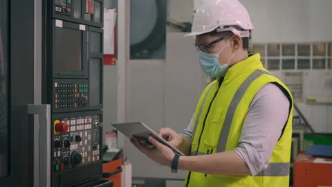 Worker man operating automated programming CNC milling control machine 库存影片 150480970